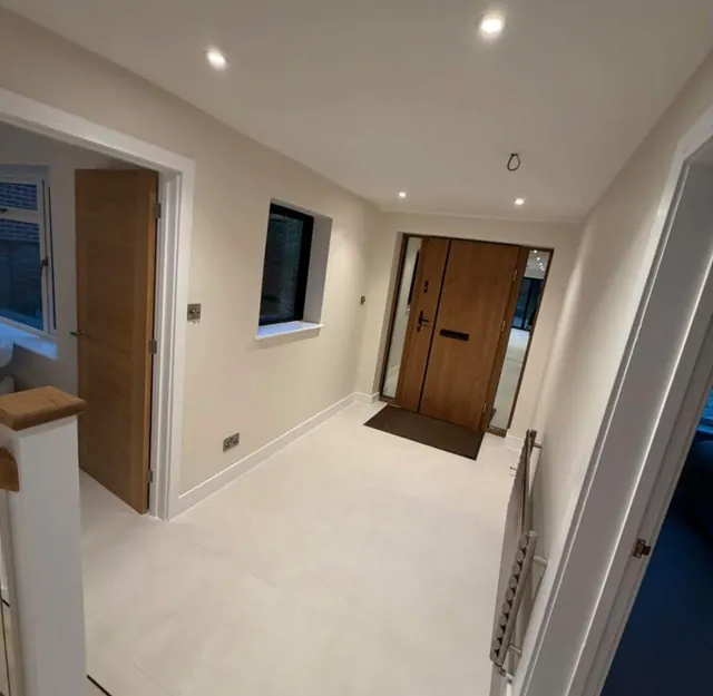 Entrance hall with an oak front door and a pale tiled floor