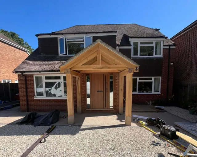 Oak-frame porch on the front of a brick house