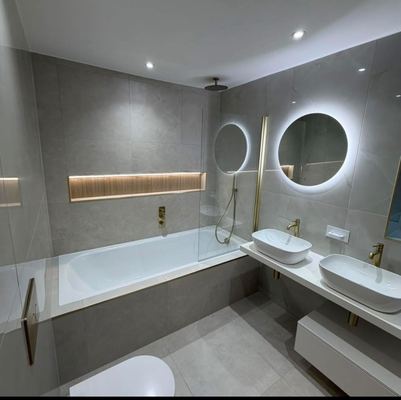 Tiled family bathroom with a bath, walk-in shower screen and twin countertop basins